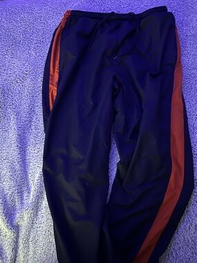 Men's navy Nike lined winter pants with orange side stripe